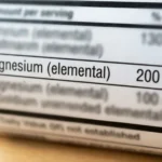Close-up of a supplement label with the Magnesium (elemental) 200 mg row in sharp focus